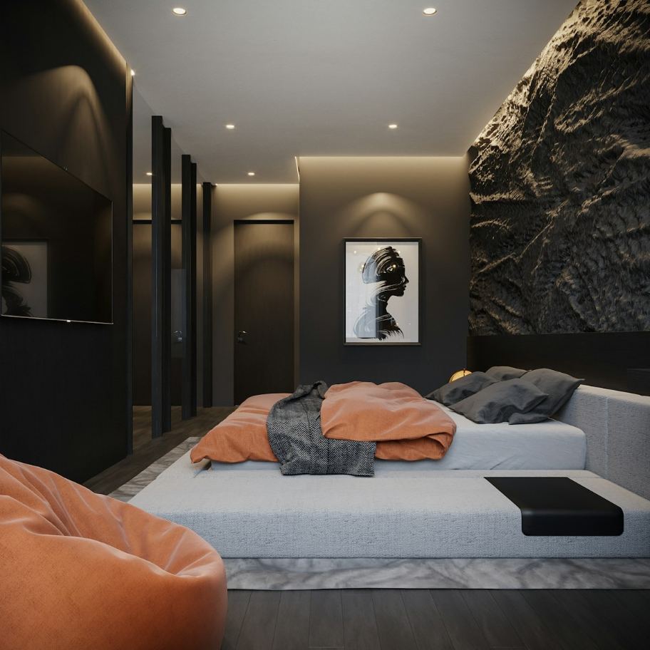 Highly dramatic luxury bedroom interior design in San Francisco, featuring a bold, dark textured stone accent wall and sophisticated recessed lighting. The low-profile platform bed is dressed in terracotta orange and charcoal gray bedding, complemented by an oversized orange beanbag chair, reflecting high-end, urban design trends popular in the Mission District. This visualization captures a sophisticated, high-contrast luxury bedroom concept, ideal for modern San Francisco living spaces. The design achieves dramatic flair through the use of dark finishes, including a prominent, coarsely textured black rock wall that serves as the focal point. Carefully planned cove and spot lighting highlights the architectural details. The platform bed, with its striking orange duvet, offers a warm contrast to the room's cool, dark aesthetic, creating a cozy yet intensely stylish retreat perfect for a high-rise residence near the Mission District (Lat 37.767296, Lng -122.419498).